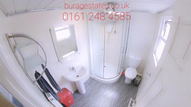 Bright, well-maintained bathroom with a curved ...