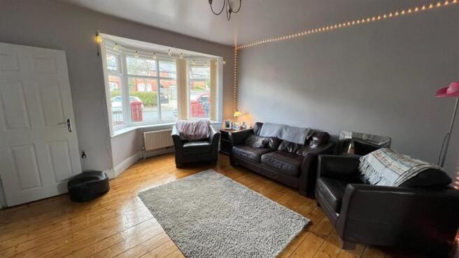 Bright, well-presented living room with a large...