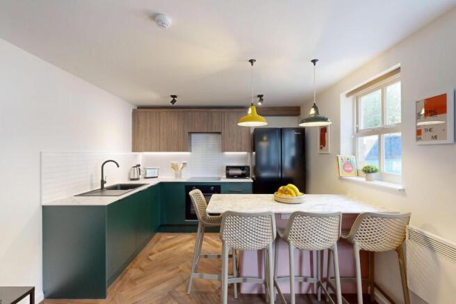 Bright modern kitchen with a central island and...