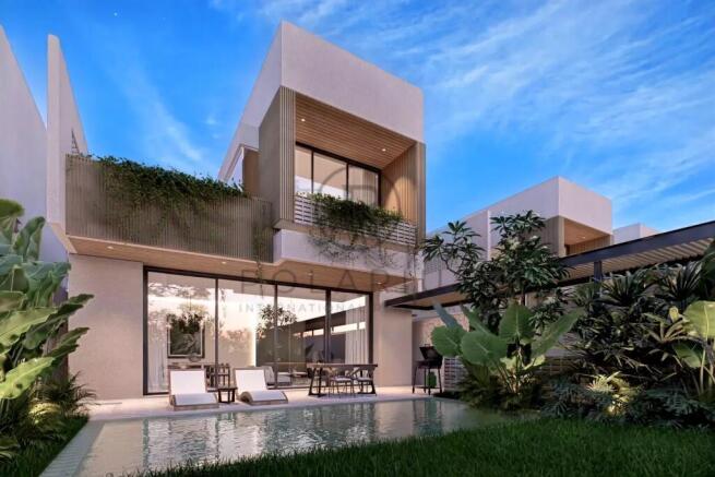 Modern house with large windows, surrounded by gre
