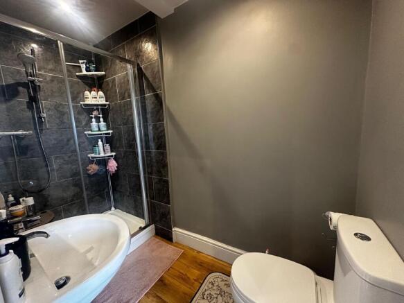 Modern bathroom with a walk-in shower, white ba...