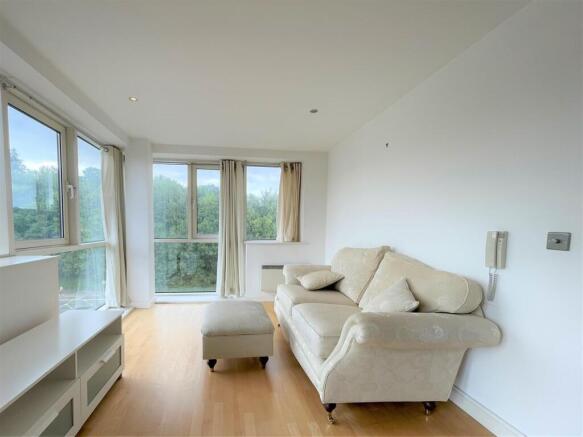 Bright lounge with large windows and comfy sofa...