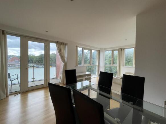Bright living area with balcony and floor windo...