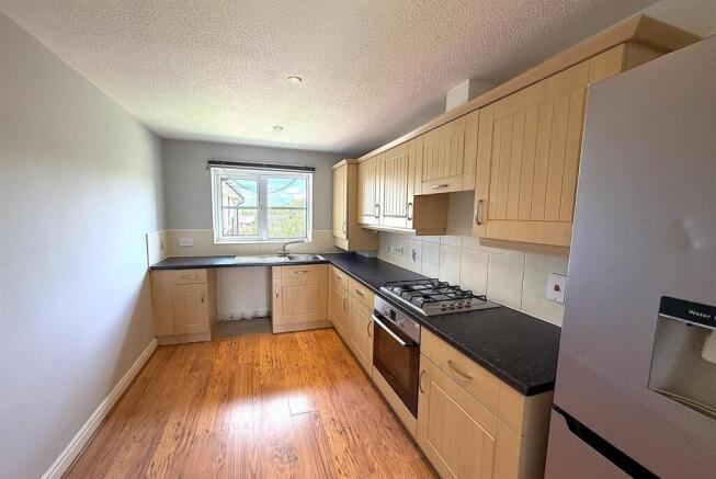 Bright kitchen with ample counter space and ove...