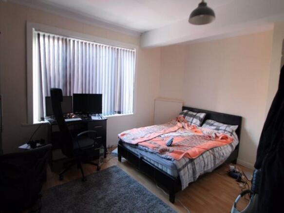 A cozy bedroom featuring a double bed, a large ...