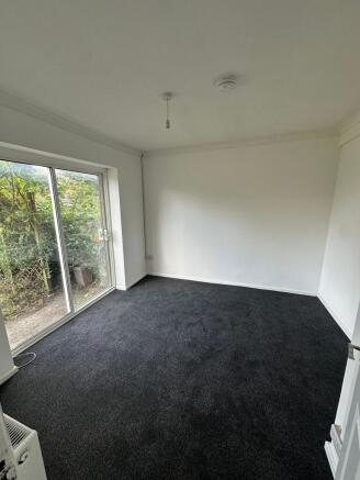 Bright and spacious bedroom featuring large sli...