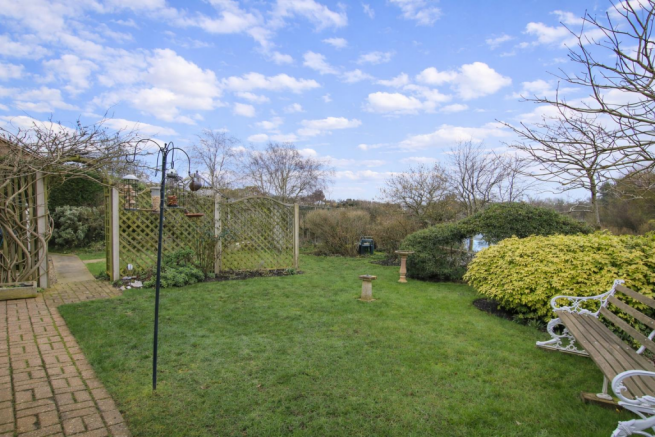 A peaceful garden with bird feeders.png