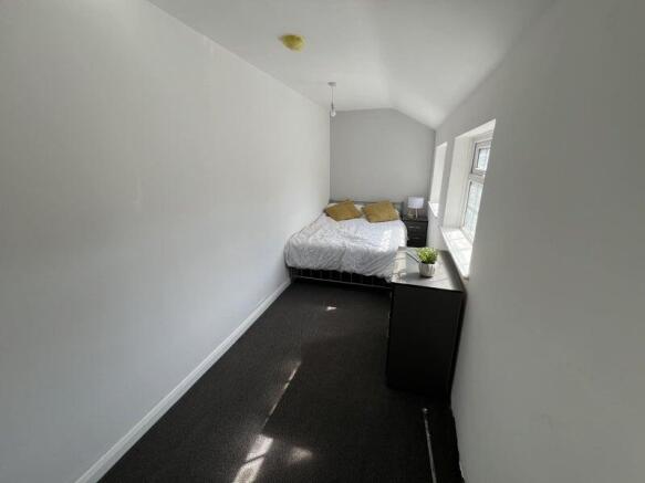 Bright and tidy double bedroom featuring a comf...