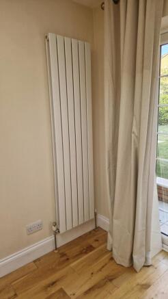 Modern radiator and stylish wooden flooring...