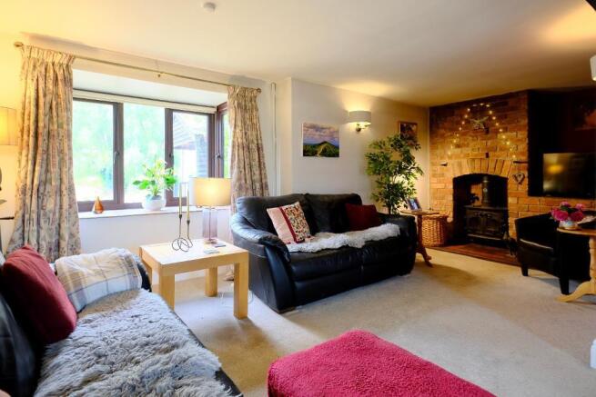 Inviting sitting room with log burner