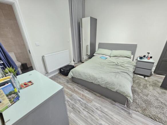 A modern, neatly arranged bedroom featuring a c...