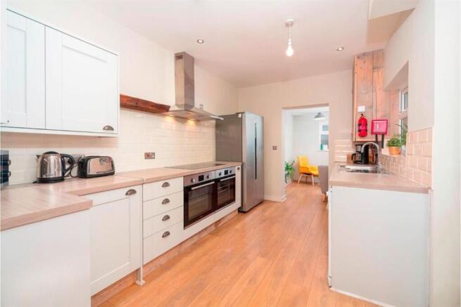 Modern kitchen with large fridge and double ove...
