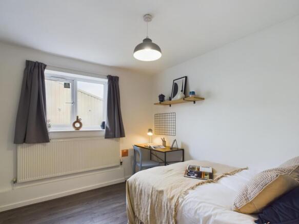 A bright and inviting double bedroom featuring ...