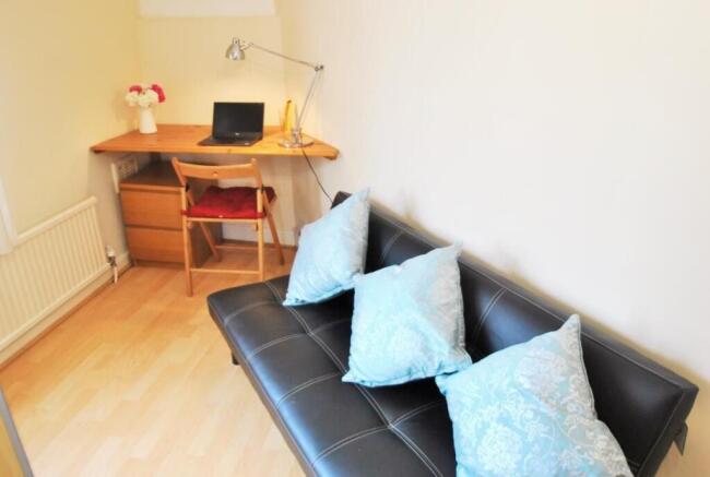 Bright workspace with stylish sofa and desk...