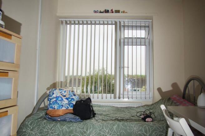 Bright bedroom with large window and scenic vie...
