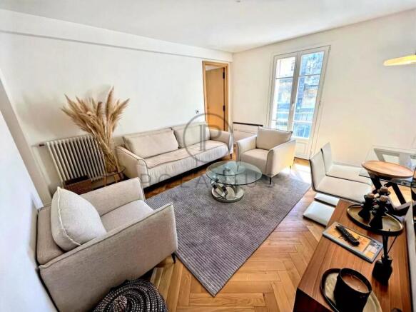A cozy, modern living room with neutral tones, fea