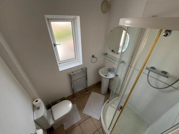 Bright, well-maintained bathroom with a corner ...