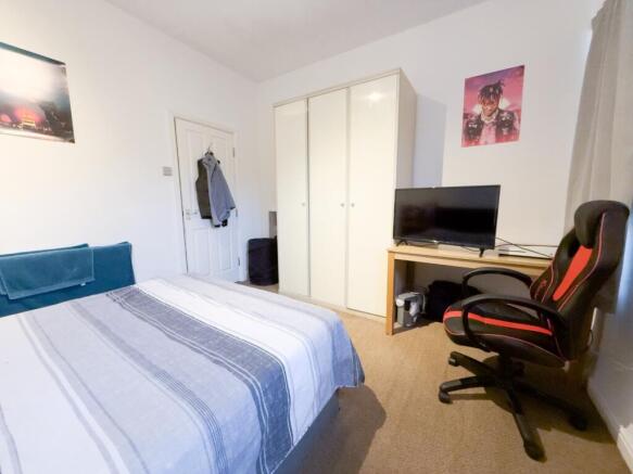 Bright, tidy bedroom with wardrobe and desk...