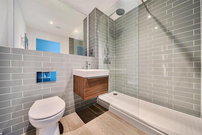 Modern bathroom with sleek gray tiling....
