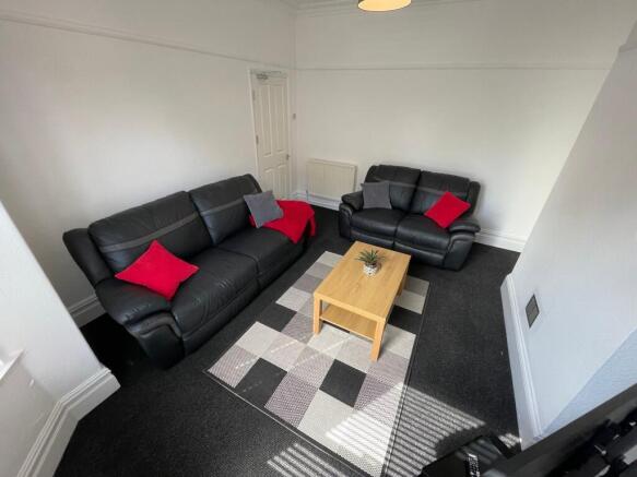 Bright, neatly furnished living room with two b...