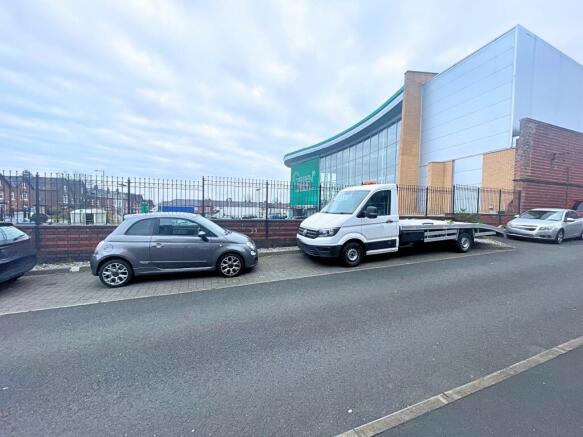 Allocated parking to side of property.