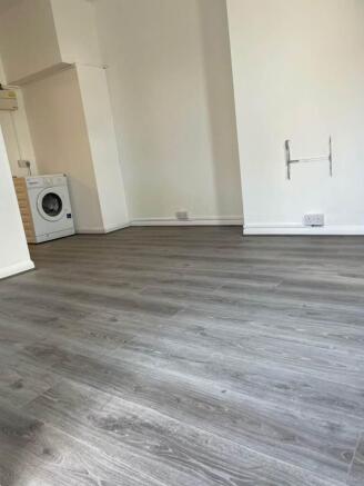 Bright open-plan room with new grey flooring...