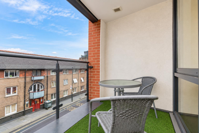 Crisp Urban Balcony with Rattan Seating.png