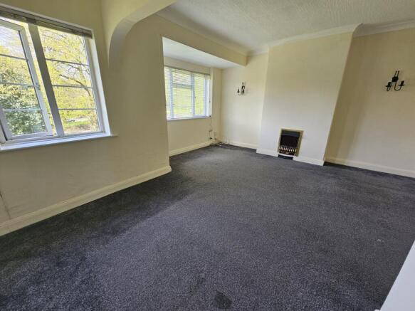 Bright living room with two large windows allow...