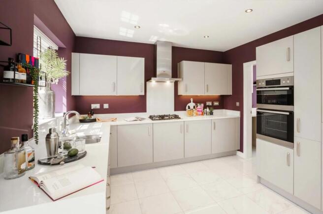 A modern, well-equipped kitchen with white cabinets, stainless steel appliances