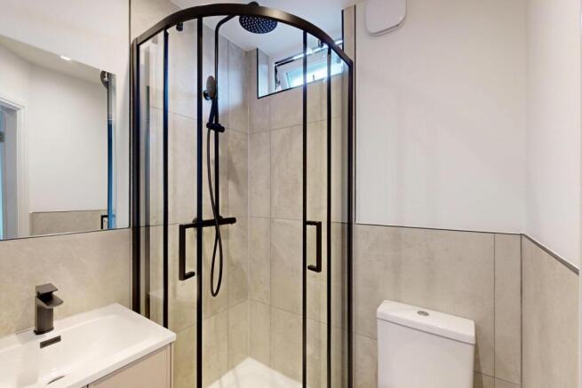 A clean, modern bathroom featuring a spacious s...