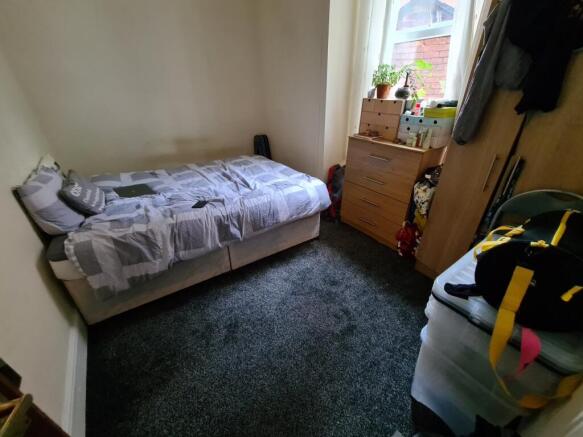 A cozy bedroom with a single bed, a window brin...