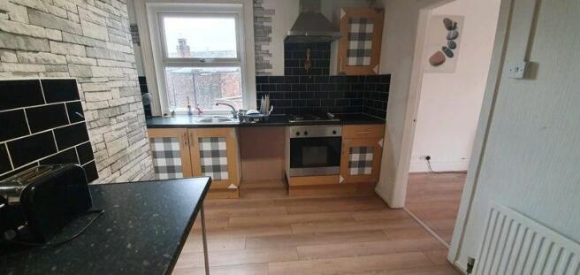 Modern kitchen with stylish splashback tiling...