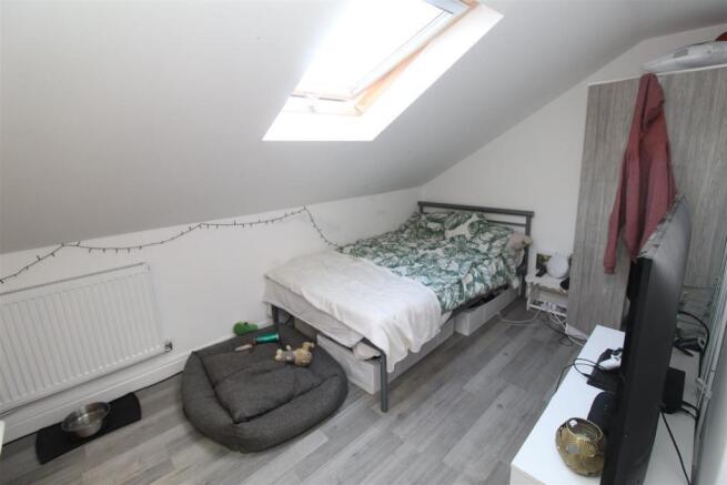 Bright attic bedroom with large skylight window...