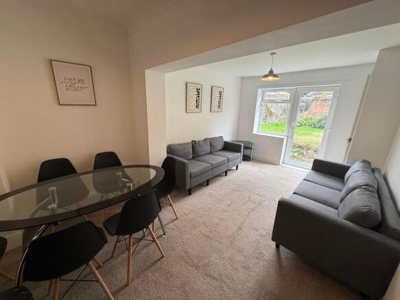 Bright, neutral living room with two matching g...