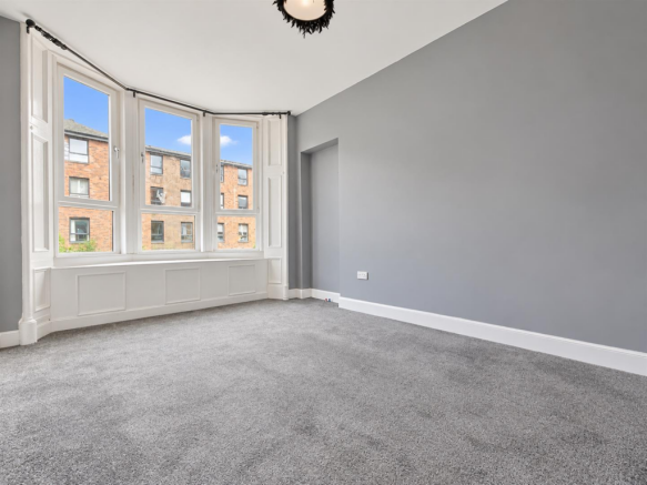 Bright Empty Room with Bay Windows.png