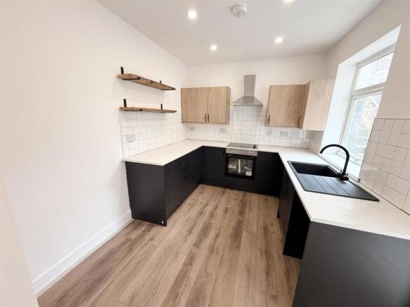 Modern kitchen with sleek dark cabinets....