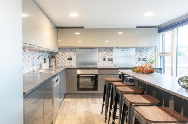 A modern and clean kitchenette with stylish fin...