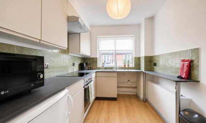 Bright and tidy kitchen with ample counter spac...