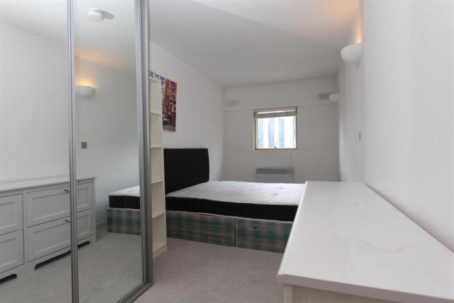Bright double bedroom with mirrored storage...
