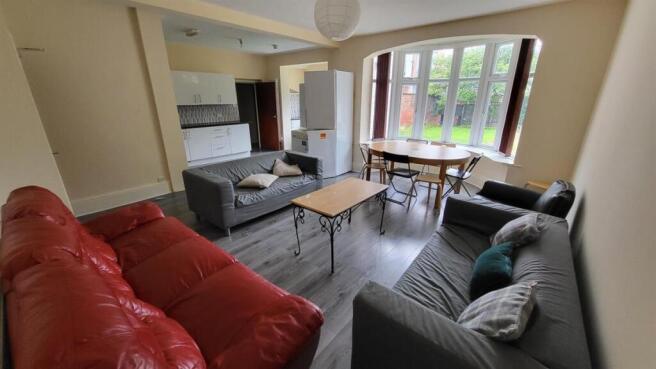 Bright, furnished living room with multiple sof...