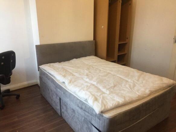 Bright, simply furnished double bedroom with a ...