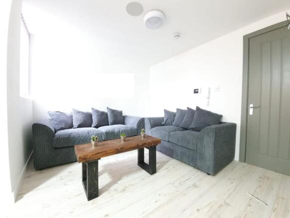 A bright and inviting living room featuring com...