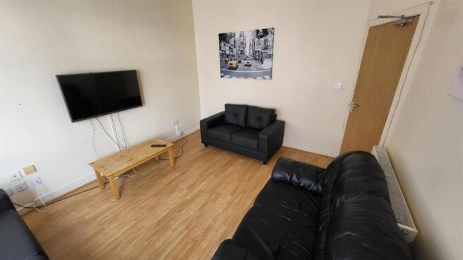 Bright, well-kept living area with wood-effect ...
