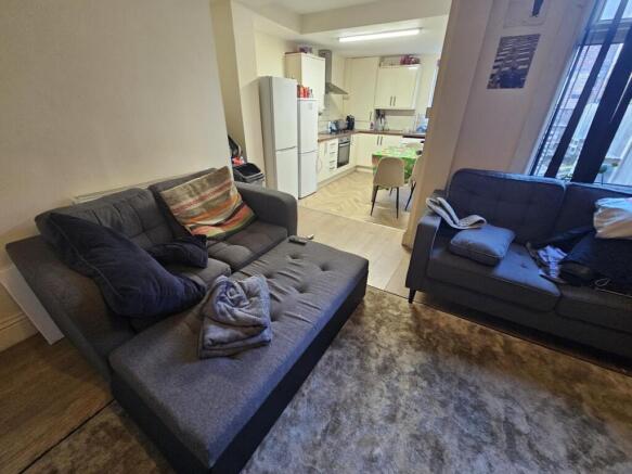 Comfortable open-plan living area with two sofa...