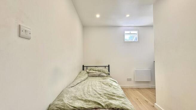 Cozy bright bedroom with clean wooden flooring...