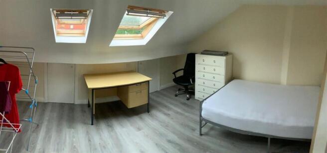 Bright attic double bedroom with two skylight w...