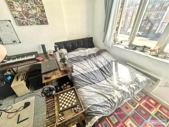 Bright bedroom with large window and study desk...