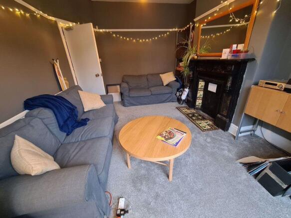 A modern, well-lit living room featuring a comf...