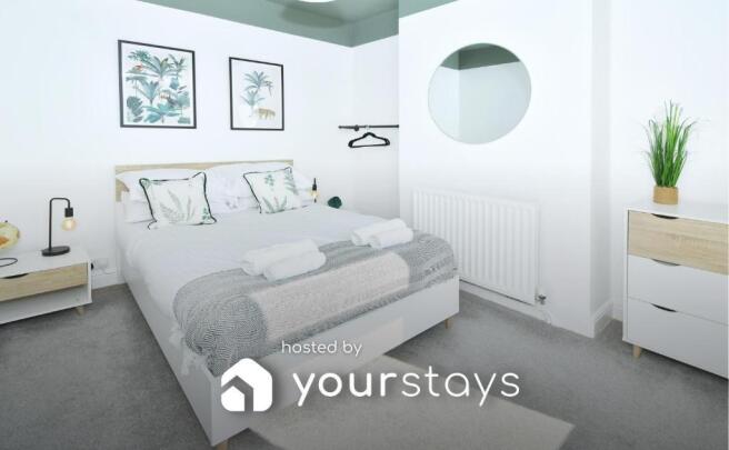 Bright, tastefully styled double bedroom with a...