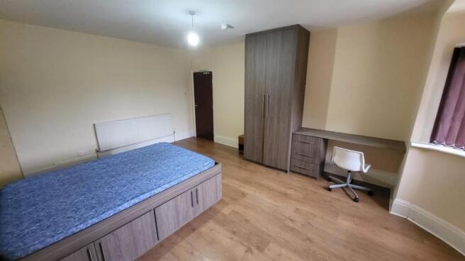 Bright, well-maintained bedroom featuring built...